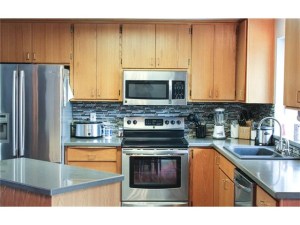Beautiful kitchen with new countertops, backsplash, and ceramic